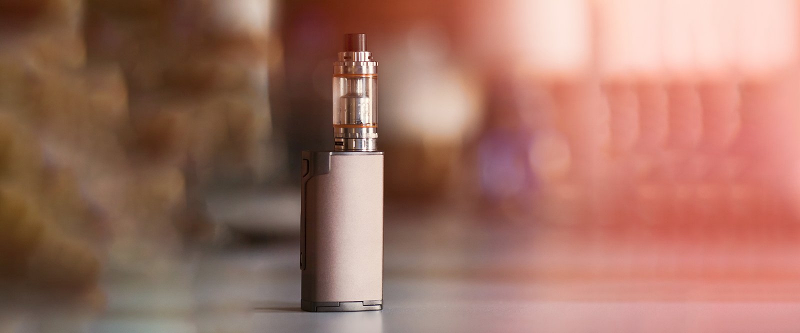 vape, electronic cigarette. blurred background. Popular smoking gadget to people who want to quit smoking nicotine cigarettes and start vaping safe glycerin vape.Trendy electronic cigarette or ecig.